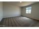 Neutral bedroom with carpeted floors and a window with a view at 9543 W Parkway Dr, Tolleson, AZ 85353