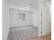 Bedroom featuring neutral carpet, a window, and a white paneled door at 9543 W Parkway Dr, Tolleson, AZ 85353