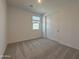 Neutral bedroom featuring a carpeted floor and a closet with bright white walls at 9543 W Parkway Dr, Tolleson, AZ 85353