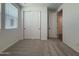 Neutral-carpeted bedroom showcasing a bright window, closet and an open doorway at 9543 W Parkway Dr, Tolleson, AZ 85353