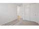 Bedroom with neutral carpet, sliding closet and door to hallway at 9543 W Parkway Dr, Tolleson, AZ 85353
