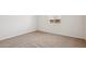 Bedroom featuring neutral carpet, a window, and bright white walls at 9543 W Parkway Dr, Tolleson, AZ 85353