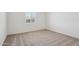 Bright bedroom features neutral carpet and a window at 9543 W Parkway Dr, Tolleson, AZ 85353
