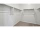 Walk in closet with carpet floors and ample shelving space at 9543 W Parkway Dr, Tolleson, AZ 85353