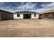 An exterior view of a partially constructed home with an unfinished yard and blue skies at 9543 W Parkway Dr, Tolleson, AZ 85353