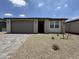 Charming single-story home with desert landscaping and a two-car garage on a sunny day at 9543 W Parkway Dr, Tolleson, AZ 85353