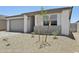 Attractive single-story home featuring desert landscaping and a modern design with a two-car garage at 9543 W Parkway Dr, Tolleson, AZ 85353