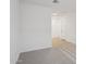 View of hallway leading to carpeted bedroom with white door at 9543 W Parkway Dr, Tolleson, AZ 85353