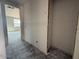 Bright hallway with unfinished walls and flooring with a doorway leading to a room at 9543 W Parkway Dr, Tolleson, AZ 85353