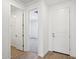 Hallway to bedroom shows open door, with view to bedroom, light flooring, and white walls at 9543 W Parkway Dr, Tolleson, AZ 85353