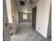Spacious hallway with unfinished walls, smooth flooring, and doorway at 9543 W Parkway Dr, Tolleson, AZ 85353