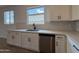 Kitchen with stainless steel appliances, undermount sink, quartz countertop, and white cabinets at 9543 W Parkway Dr, Tolleson, AZ 85353