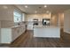 Modern kitchen with white cabinets, stainless steel appliances, and a kitchen island at 9543 W Parkway Dr, Tolleson, AZ 85353