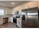 Modern kitchen featuring stainless steel appliances, white cabinets, and light countertops at 9543 W Parkway Dr, Tolleson, AZ 85353