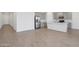 Modern kitchen and living area featuring stainless steel appliances, gray cabinets, and wood-look floors at 9543 W Parkway Dr, Tolleson, AZ 85353