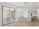 Open concept living room and kitchen features sliding glass doors and seamless living spaces at 9543 W Parkway Dr, Tolleson, AZ 85353