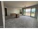 Spacious living room with sliding glass doors leading to the backyard at 9543 W Parkway Dr, Tolleson, AZ 85353