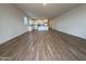 Open-concept living room featuring tile floors and a view of the modern kitchen at 9543 W Parkway Dr, Tolleson, AZ 85353