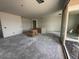A partially constructed living room with unfinished walls, floors, and a large sliding glass door at 9543 W Parkway Dr, Tolleson, AZ 85353