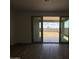 Living space with tile floors and sliding doors to the backyard at 9543 W Parkway Dr, Tolleson, AZ 85353