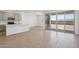 Open-concept living space features wood-look floors, modern gray cabinets, and sliding glass doors at 9543 W Parkway Dr, Tolleson, AZ 85353