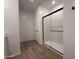 Modern bathroom featuring a glass-enclosed shower with black trim at 9543 W Parkway Dr, Tolleson, AZ 85353