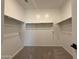 Walk-in closet with ample shelving and carpeting at 9543 W Parkway Dr, Tolleson, AZ 85353