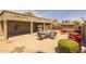 Inviting backyard patio featuring a fire pit table, lounge chairs, and covered seating area for entertaining at 10621 W Pima St, Tolleson, AZ 85353