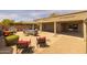 Covered patio with outdoor furniture and a landscaped backyard perfect for enjoying the outdoors at 10621 W Pima St, Tolleson, AZ 85353
