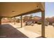 Spacious backyard with covered patio, storage shed, gravel area, and outdoor dining set for relaxing at 10621 W Pima St, Tolleson, AZ 85353
