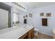 Bright bathroom featuring a single sink vanity, a large mirror, and ample countertop space at 10621 W Pima St, Tolleson, AZ 85353