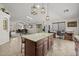 Open kitchen with granite countertops, center island, stainless steel appliances and pendant lighting at 10621 W Pima St, Tolleson, AZ 85353