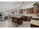 Modern kitchen features a center island with seating, granite countertops and stainless steel appliances at 10621 W Pima St, Tolleson, AZ 85353