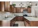 Modern kitchen featuring granite countertops, a tile backsplash, and stainless steel appliances at 10621 W Pima St, Tolleson, AZ 85353