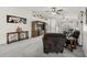 Open living area features neutral carpet, ceiling fan, and built-in shelving at 10621 W Pima St, Tolleson, AZ 85353