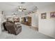 Expansive living area with plush carpet, ceiling fan, and seamless flow into the kitchen at 10621 W Pima St, Tolleson, AZ 85353
