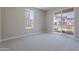 Bright bedroom with large window and sliding glass door to balcony at 11300 N Casa Dega Dr # 1027, Surprise, AZ 85388