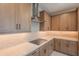 Well-lit kitchen boasts wood cabinets, modern backsplash, and stainless steel range hood above electric cooktop at 11300 N Casa Dega Dr # 1027, Surprise, AZ 85388