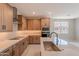 Spacious kitchen featuring stainless steel appliances, wooden cabinets, and kitchen island with marble counter tops at 11300 N Casa Dega Dr # 1027, Surprise, AZ 85388