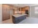 This spacious kitchen features wooden cabinets, stainless steel appliances, and a large island for food prep at 11300 N Casa Dega Dr # 1027, Surprise, AZ 85388