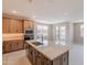Modern kitchen features stainless steel appliances, wooden cabinets, and large kitchen island with bar seating at 11300 N Casa Dega Dr # 1027, Surprise, AZ 85388