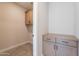 Bright laundry room with tile flooring and natural wood cabinetry at 11300 N Casa Dega Dr # 1027, Surprise, AZ 85388