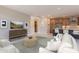 Open-concept living room with neutral tones, modern furniture, and access to the kitchen and dining area at 11300 N Casa Dega Dr # 1027, Surprise, AZ 85388