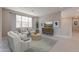 Bright living room with a large window, comfortable seating, and stylish decor with access to staircase at 11300 N Casa Dega Dr # 1027, Surprise, AZ 85388