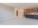 Open-concept living room and kitchen with tile flooring, ample natural light, and a stairway visible in the background at 11300 N Casa Dega Dr # 1027, Surprise, AZ 85388