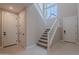 Bright entryway featuring a carpeted staircase with white banister and several white doors at 11300 N Casa Dega Dr # 1027, Surprise, AZ 85388