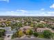 Expansive aerial view of a residential neighborhood featuring large homes, mature trees, and mountain views at 11821 S Tuzigoot Ct, Phoenix, AZ 85044