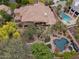 Expansive property showcasing a large home, lush landscaping, swimming pool, and covered outdoor seating areas at 11821 S Tuzigoot Ct, Phoenix, AZ 85044