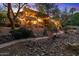 Beautiful backyard with rock landscaping, walking paths, and string lights, perfect for outdoor entertaining at 11821 S Tuzigoot Ct, Phoenix, AZ 85044