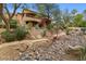 Expansive backyard featuring intricate landscaping, a decorative bridge, and a stone pathway leading to the home at 11821 S Tuzigoot Ct, Phoenix, AZ 85044